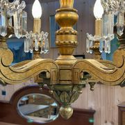 Golden wooden chandelier with crystal pendants from the 19th century.
