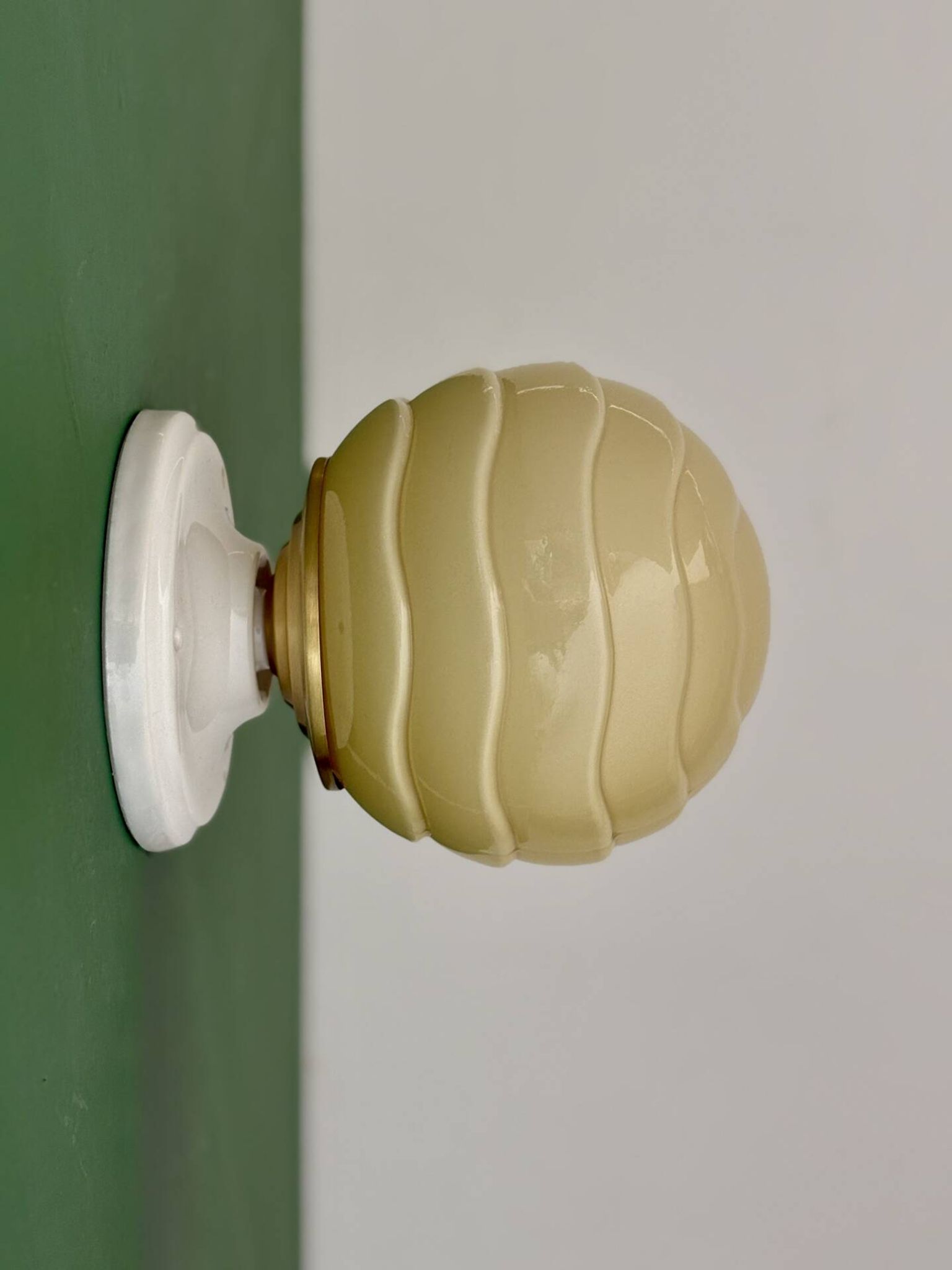 Vintage Art Deco globe wall light in pale yellow opaline.
