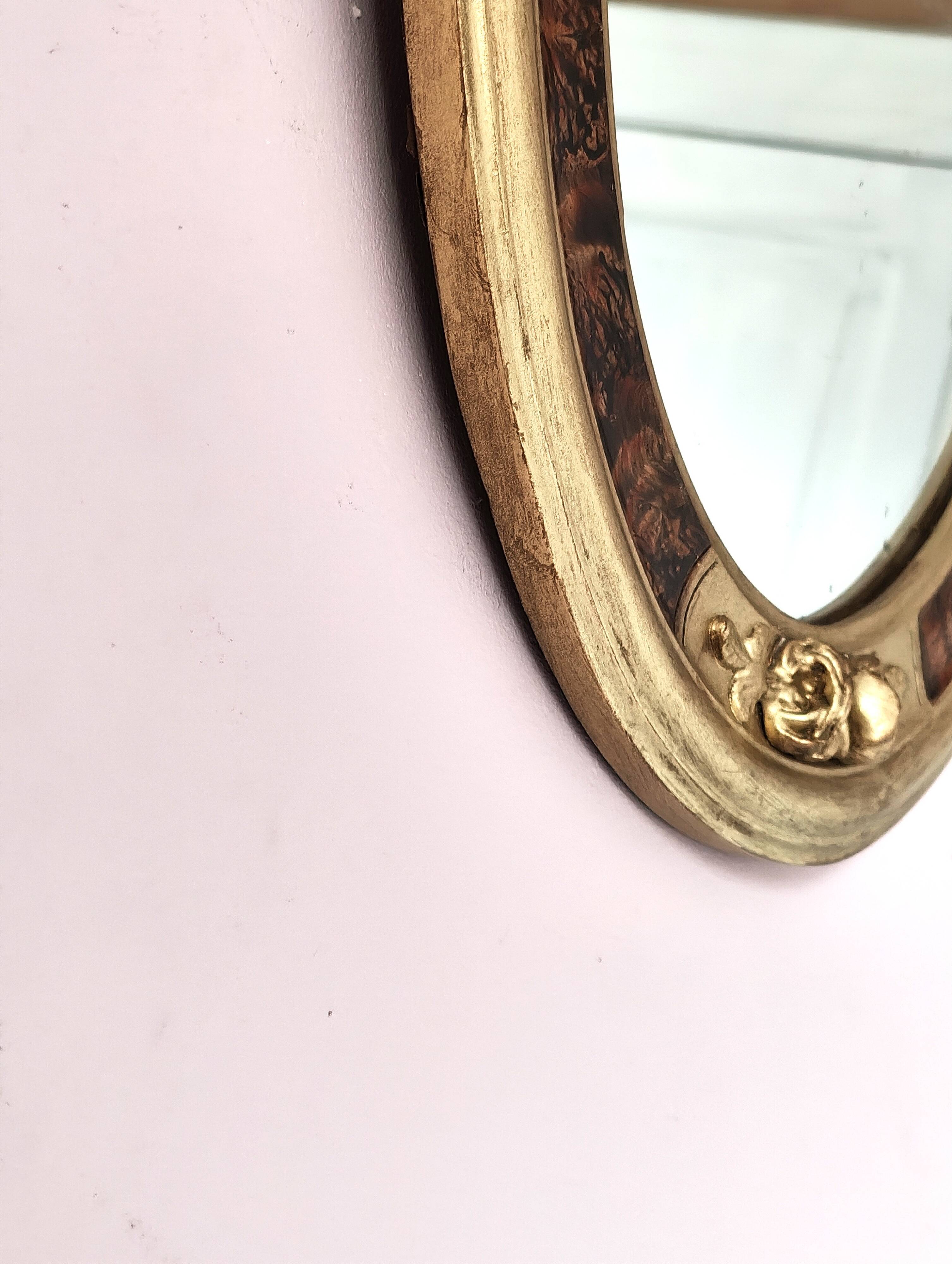 Antique medallion mirror with a gilded and relief-carved frame.