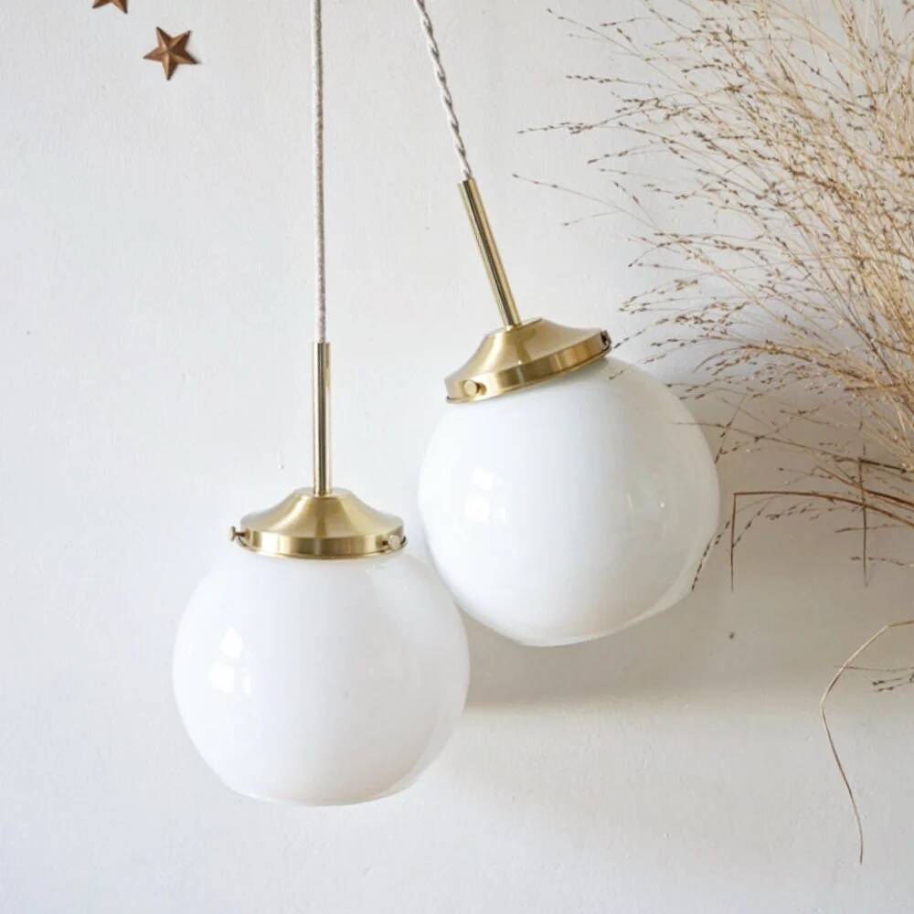 A pair of white opaline and brass suspensions.