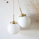 A pair of white opaline and brass suspensions.