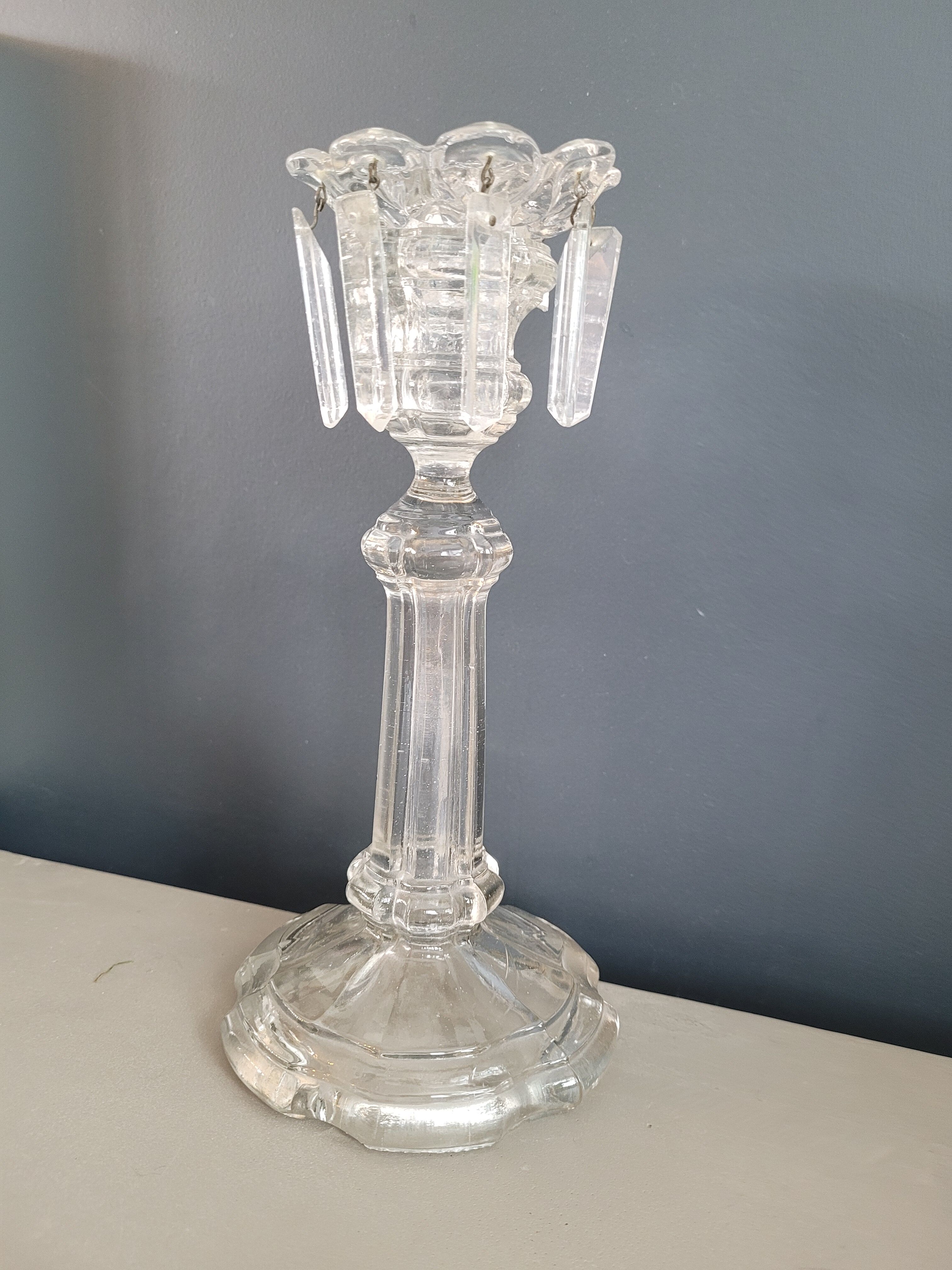 Old candlestick with molded glass stamps