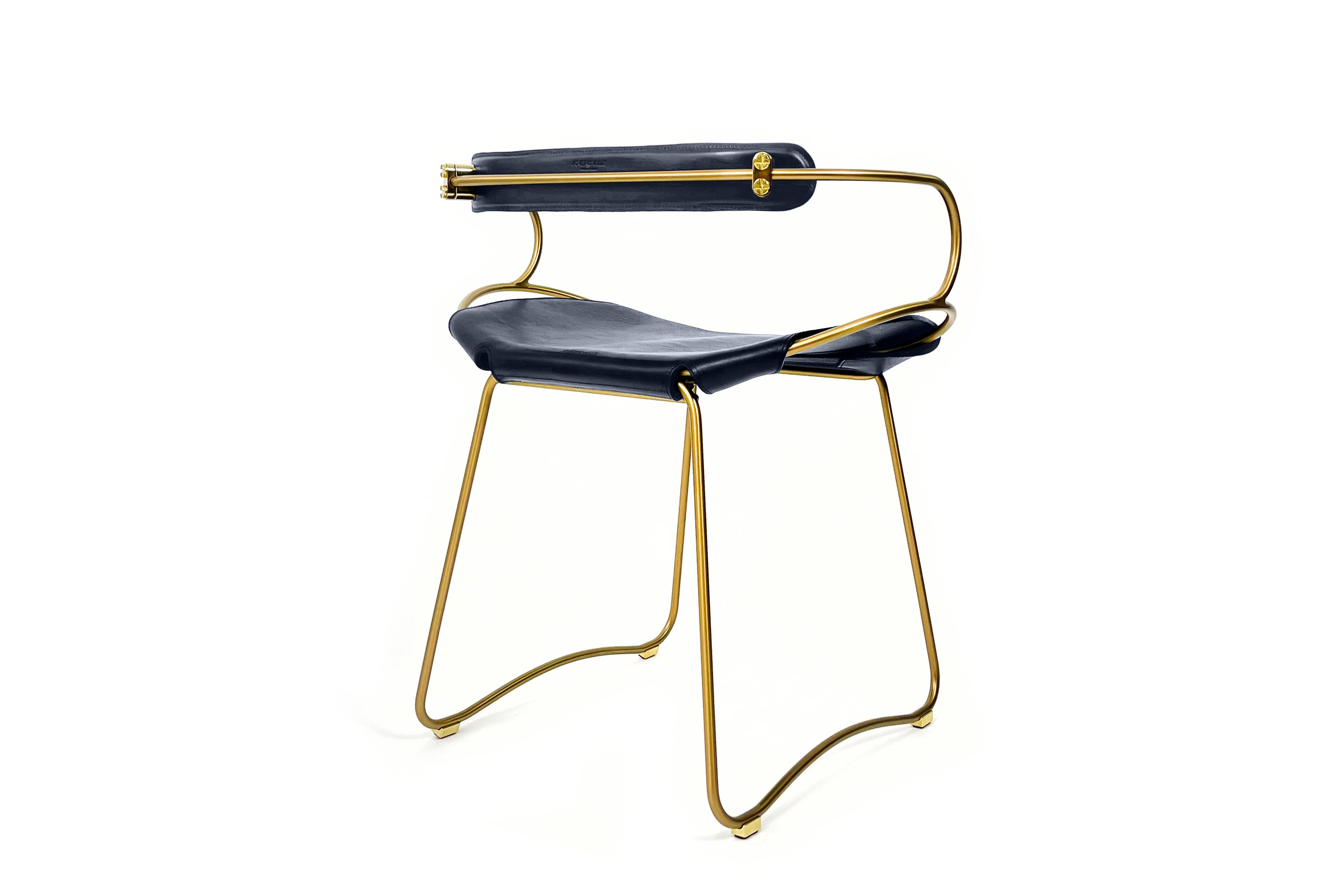 Contemporary kitchen bar stool with brass metal backrest and navy blue leather.