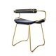 Contemporary kitchen bar stool with brass metal backrest and navy blue leather.