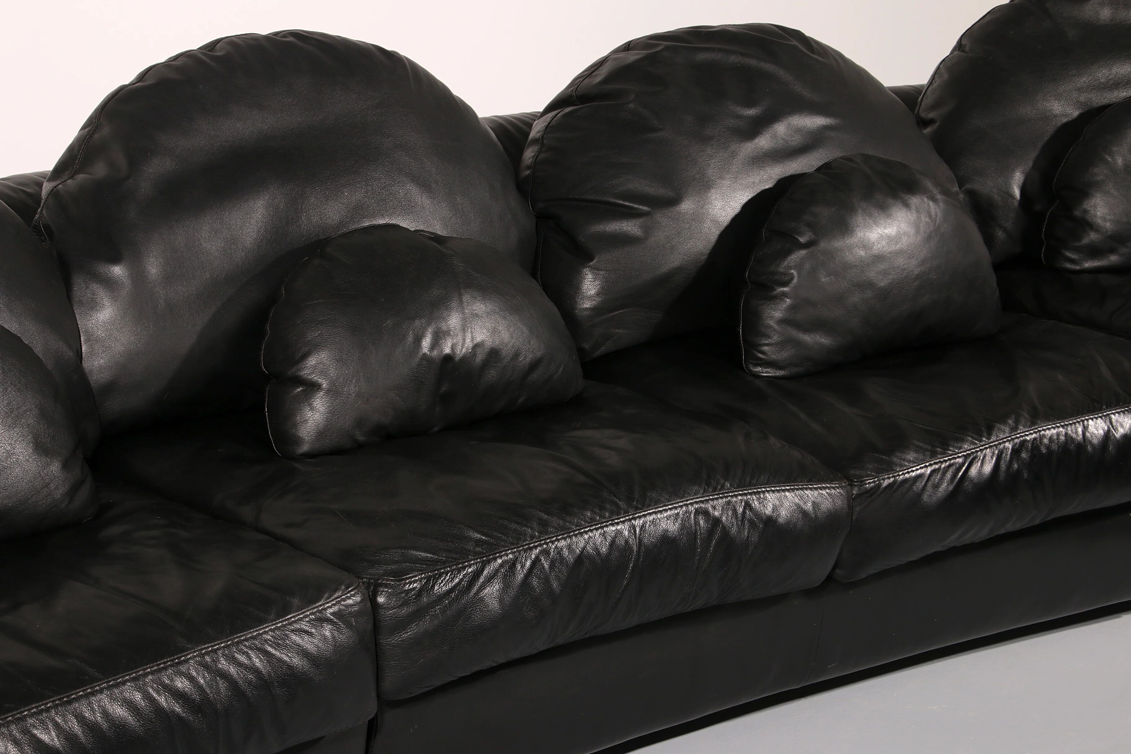 Organically shaped post-modern sectional sofa in black leather