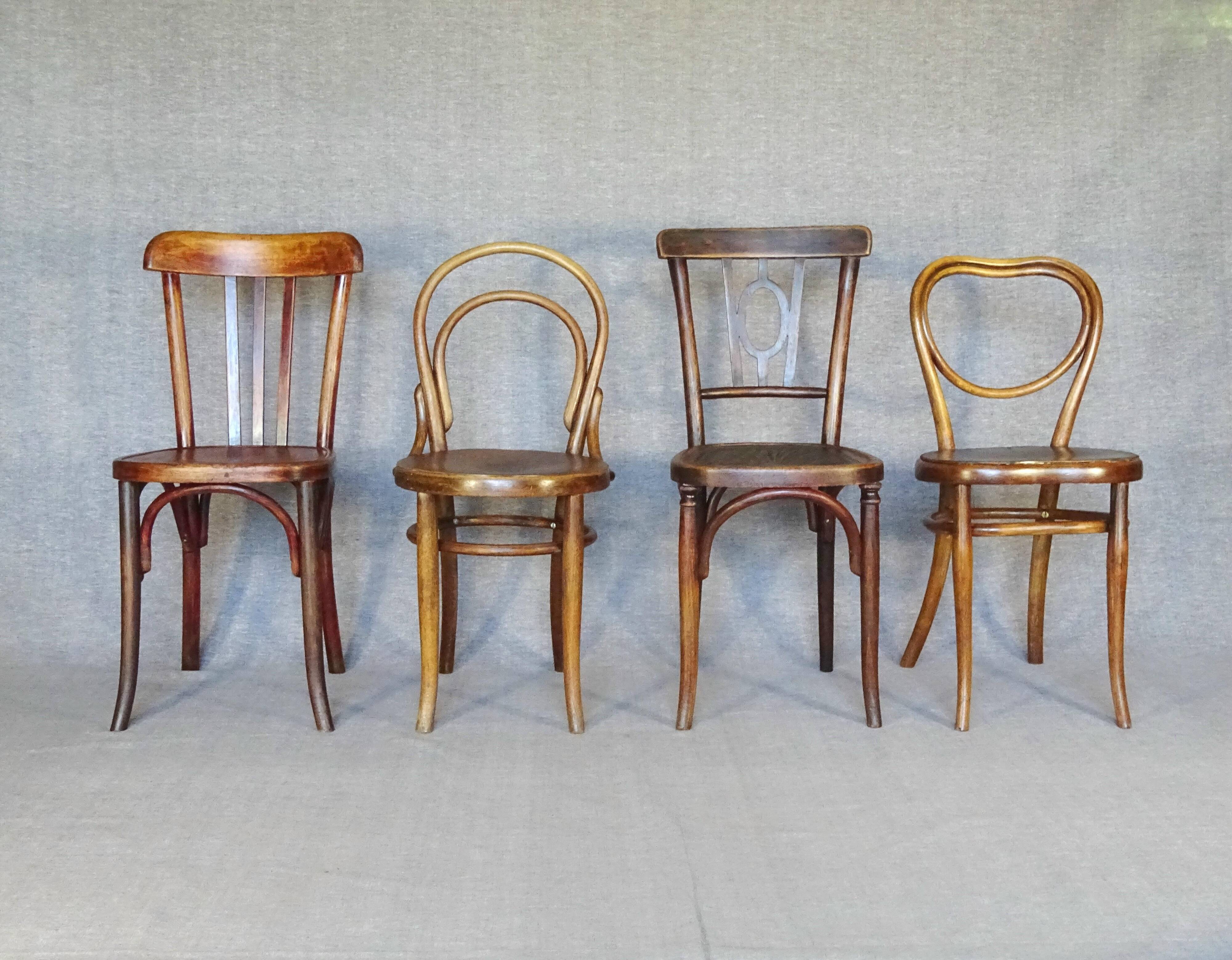 Set of 4 mismatched bistro chairs, 1900 to 1930 with wooden seats, Thonet, Baumann