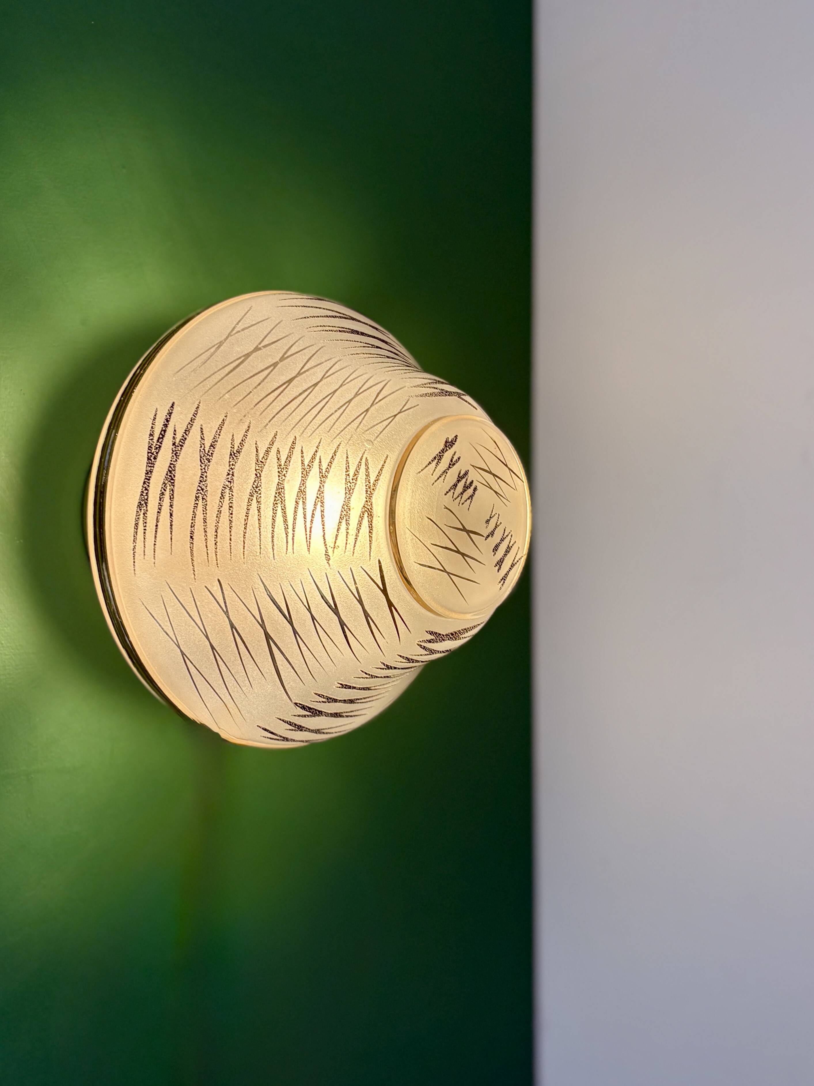 Vintage Art Deco globe wall/ceiling light in white, black, and gold glass.