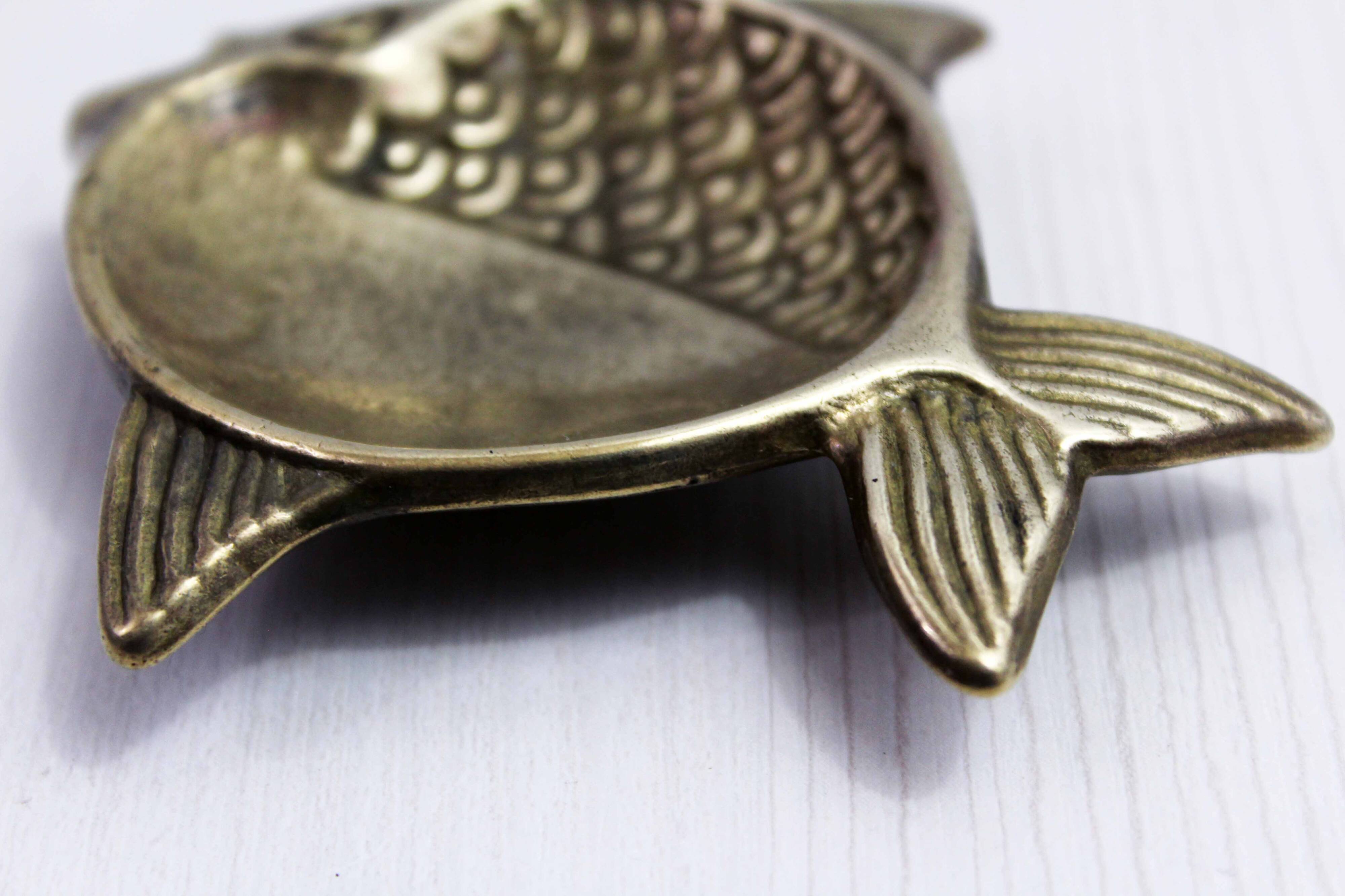 Vintage fish-shaped brass pocket emptier