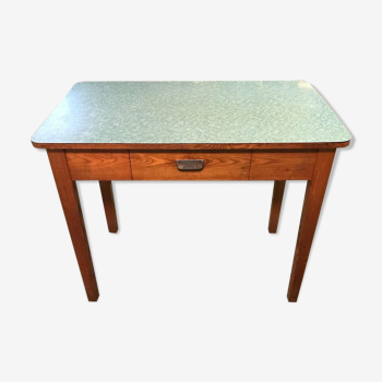 An industrial table with a formica tray
