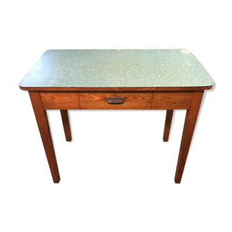 An industrial table with a formica tray
