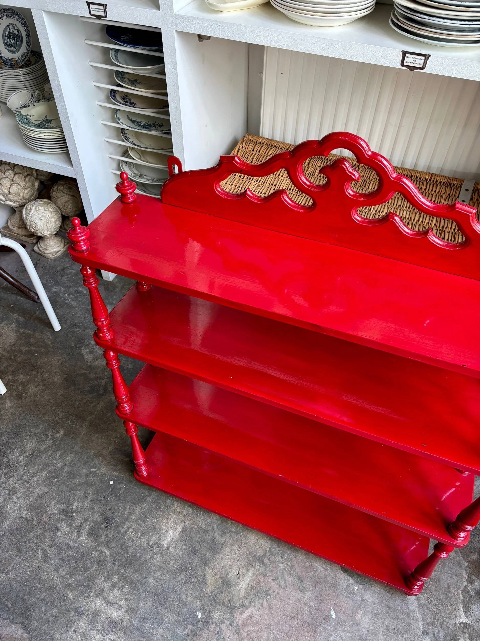 Wall shelf with 4 red lacquered wooden shelves.