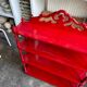 Wall shelf with 4 red lacquered wooden shelves.