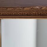 Mirror in gilded stucco wood and beveled glass