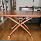 Wooden coffee table convertible into a dining table.