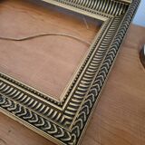 Frame with channels in wood and gilded stucco