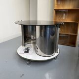 Vintage metal and smoked glass coffee table on casters bar