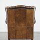 Vintage sheepskin wingback chair finished with black piping