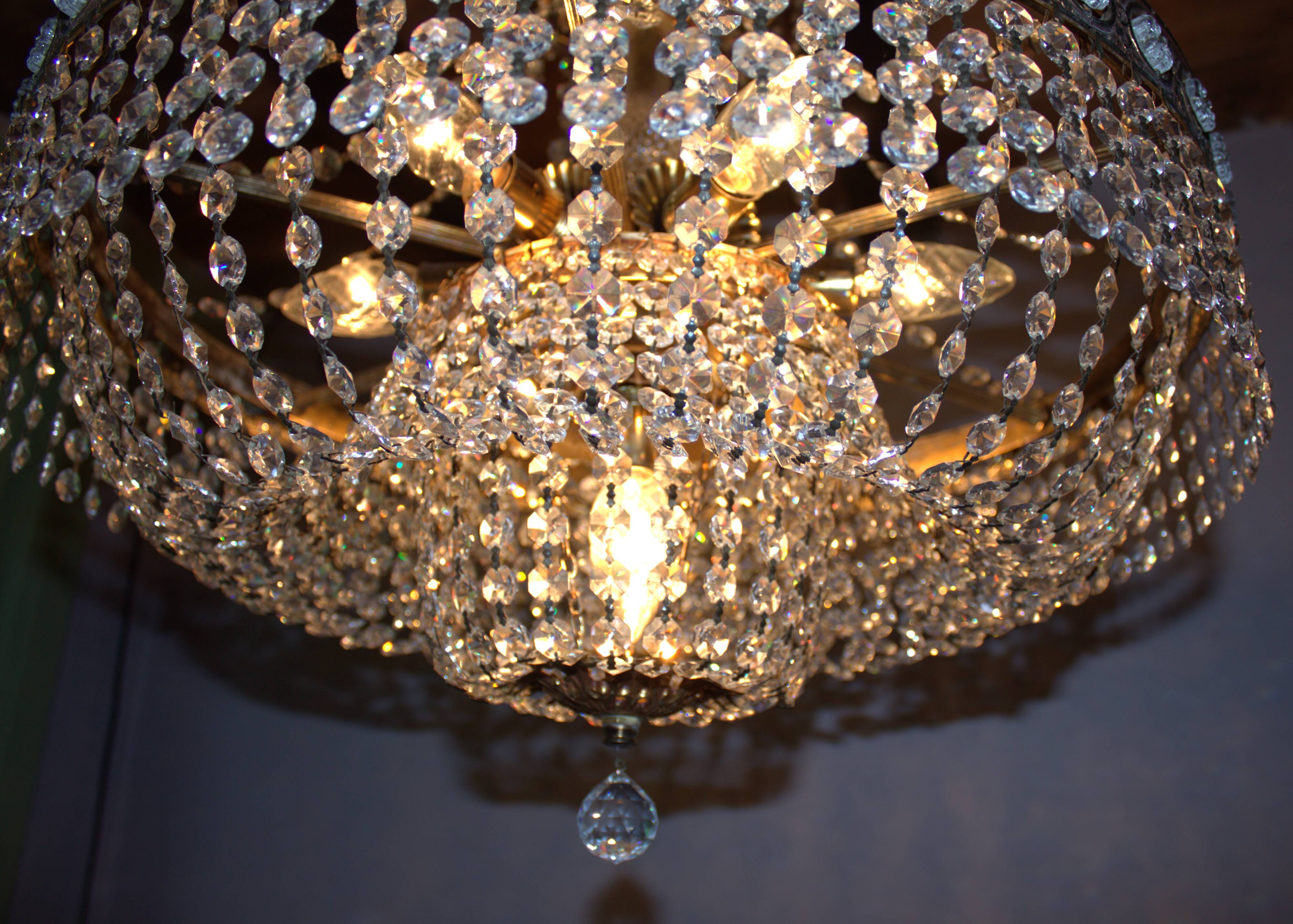 Antique castle style chandelier with tassels and floral details