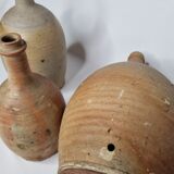 Set of three enamelled terracotta bottles