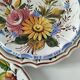 Set of three earthenware plates from Bassano, hand-painted with fruit and flower designs.