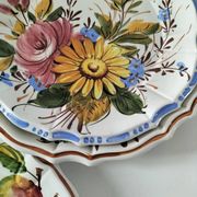Set of three earthenware plates from Bassano, hand-painted with fruit and flower designs.