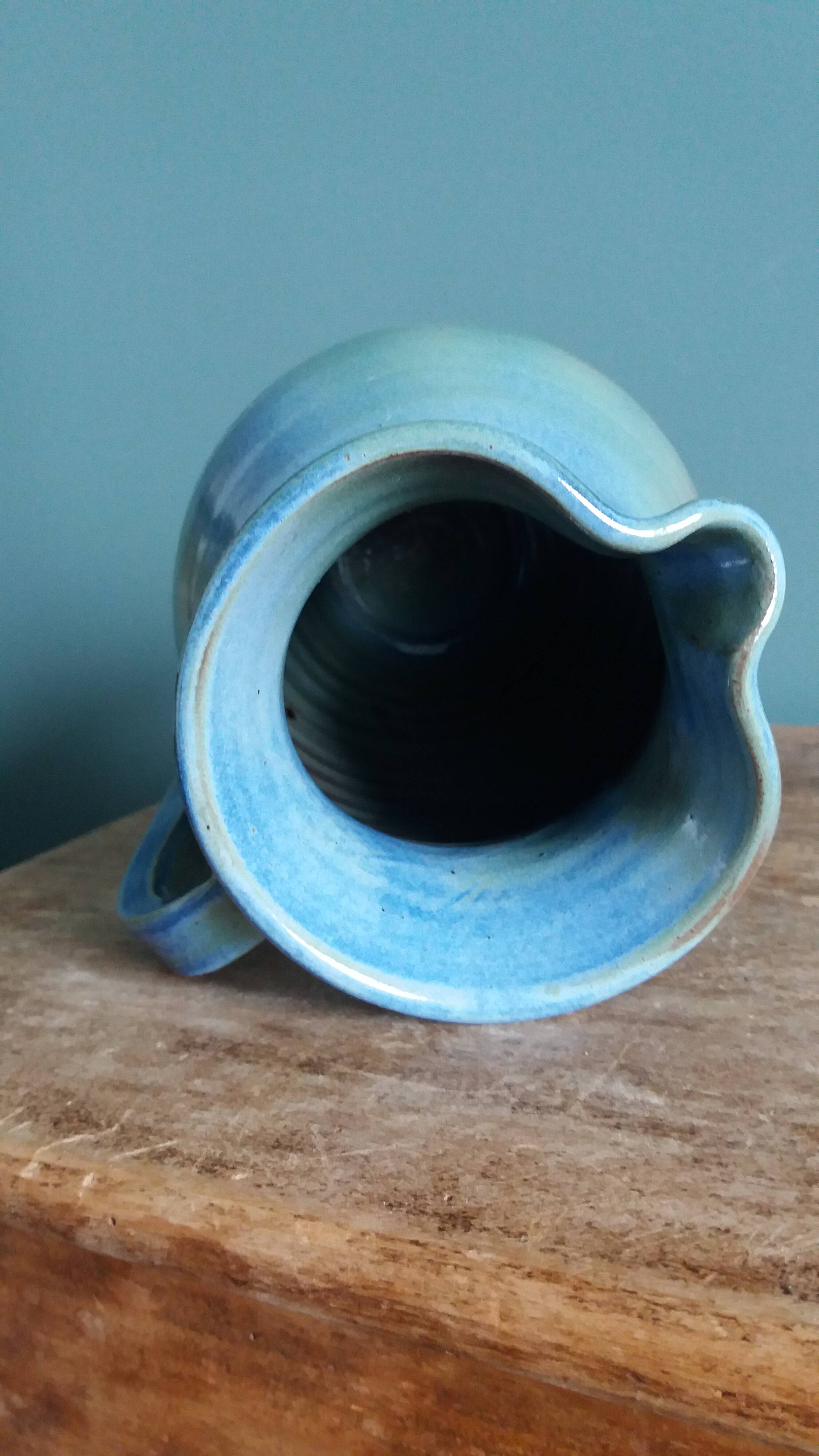 Enamel pitcher in pastel blue and green, signed