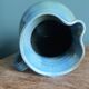 Enamel pitcher in pastel blue and green, signed