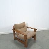 Brown-grey armchair with an oak frame.