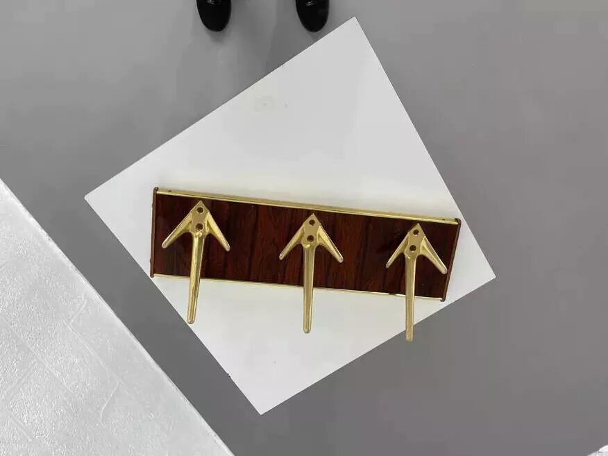 Coat rack or wall hook from the 1950s in wood and brass.