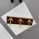 Coat rack or wall hook from the 1950s in wood and brass.