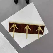 Coat rack or wall hook from the 1950s in wood and brass.