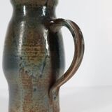 Handcrafted stoneware pitcher with blue-green hues, signed piece