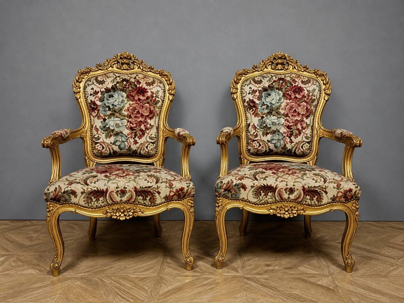 Pair of carved and gilded cabriolet armchairs in the Louis XV style.