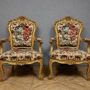 Pair of carved and gilded cabriolet armchairs in the Louis XV style.