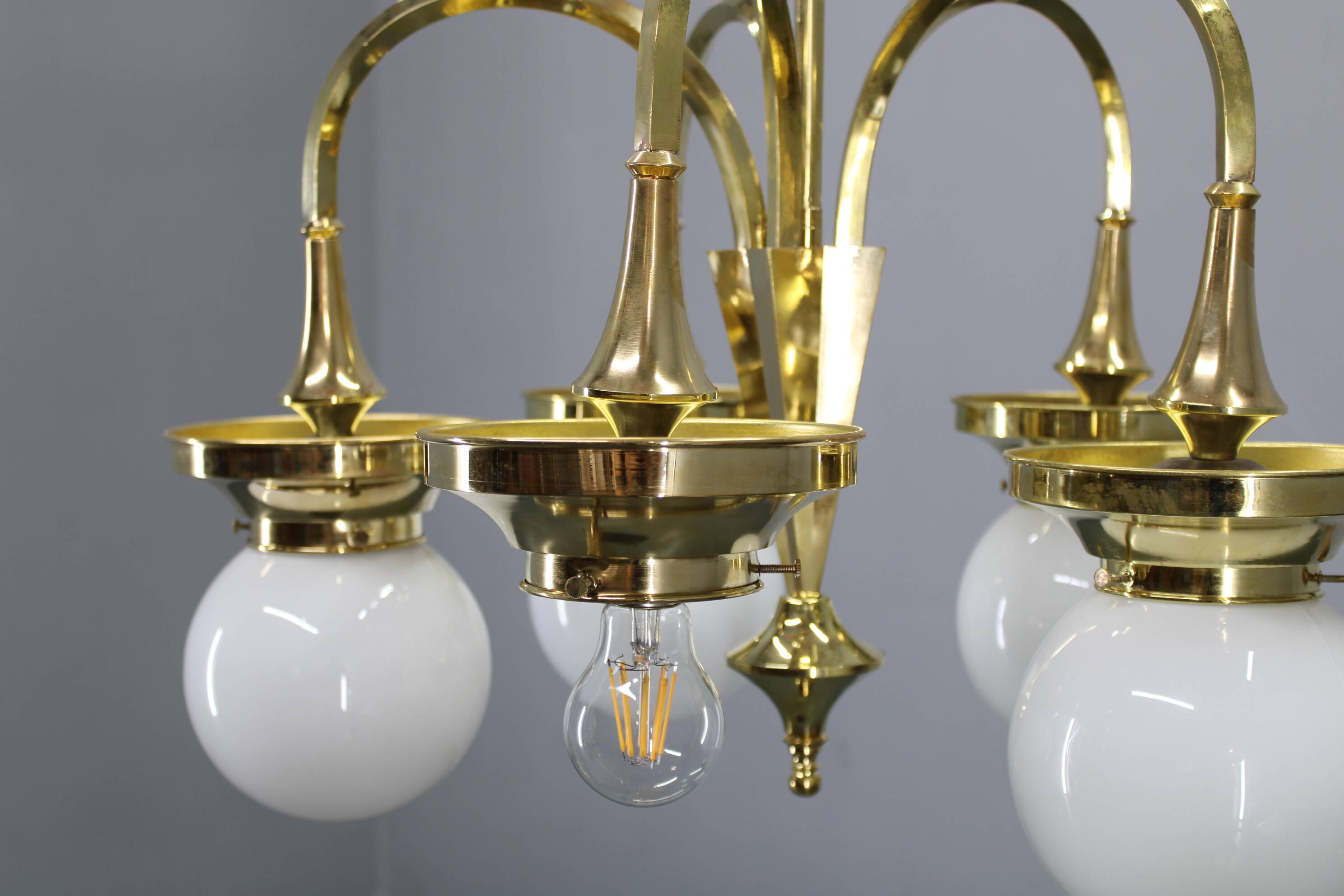 1930s Czechoslovak Art Deco brass chandelier with five opaline glass globes