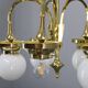 1930s Czechoslovak Art Deco brass chandelier with five opaline glass globes