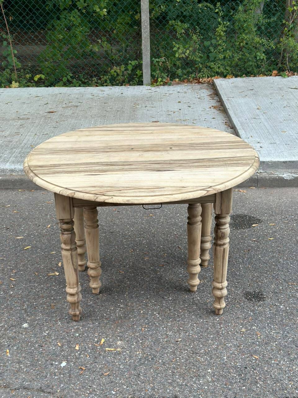 Round extendable dining table with flaps, stripped in raw oak, with 4 extensions.