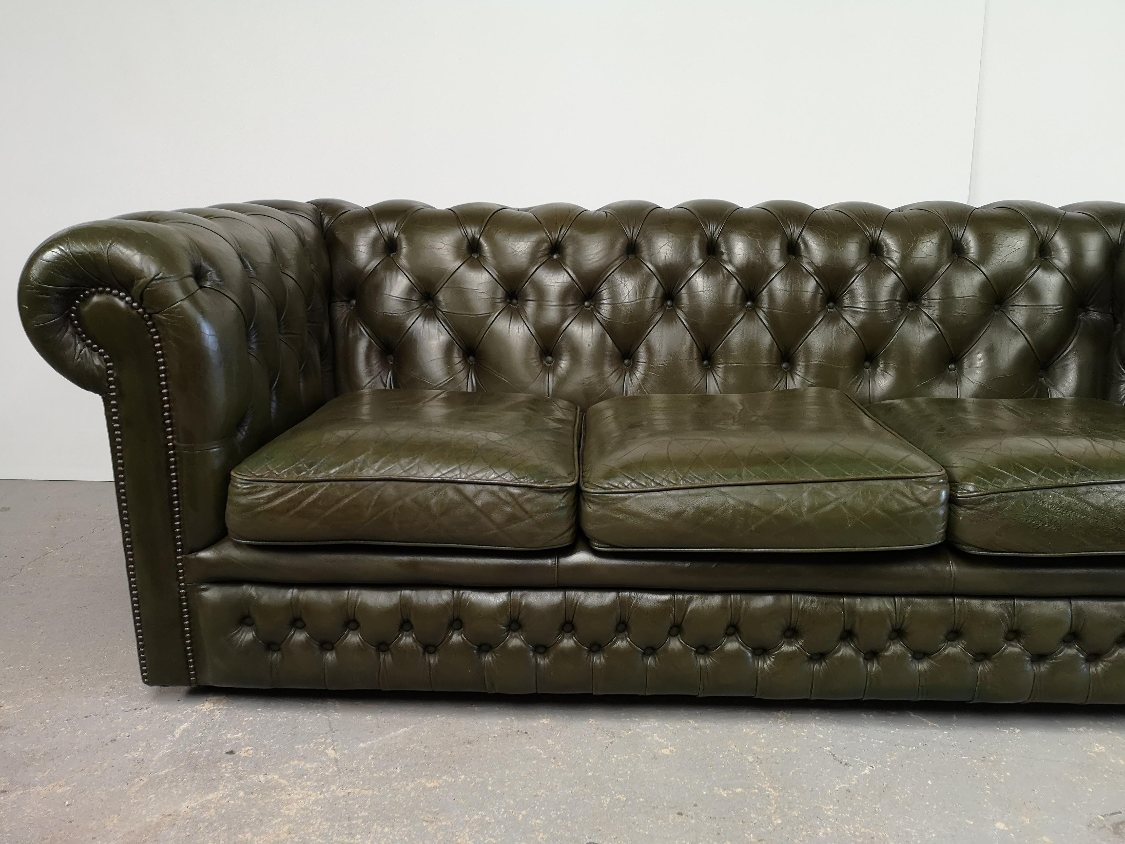 Three-seater green leather Chesterfield sofa