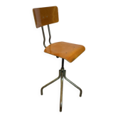 Old high workshop chair made of wood and metal