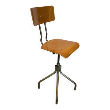 Old high workshop chair made of wood and metal.