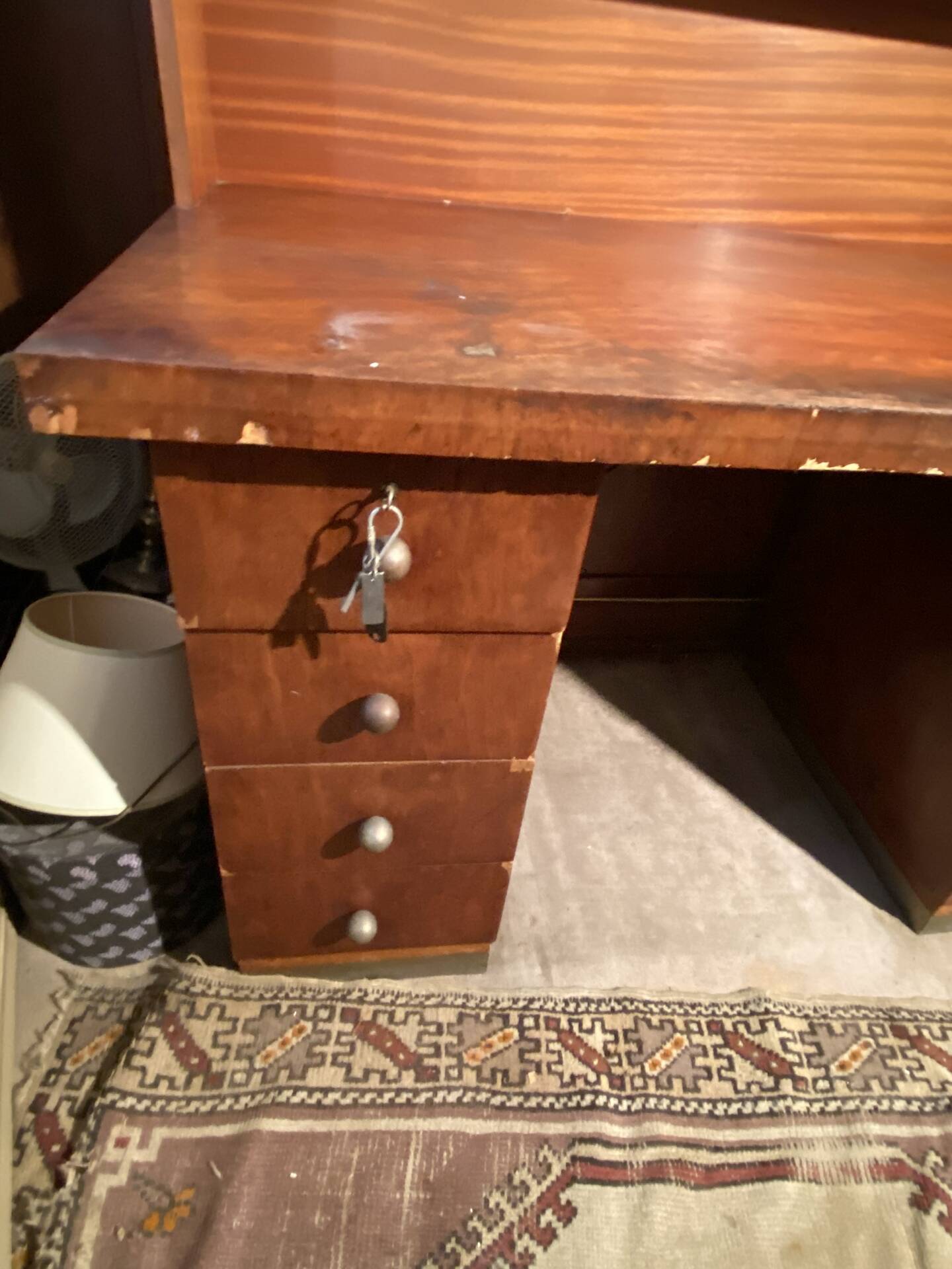 Vintage desk with drawers and a hutch with numerous drawers.