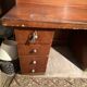 Vintage desk with drawers and a hutch with numerous drawers.