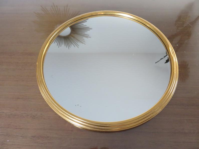 Round mirror tray in 1950s gold metal