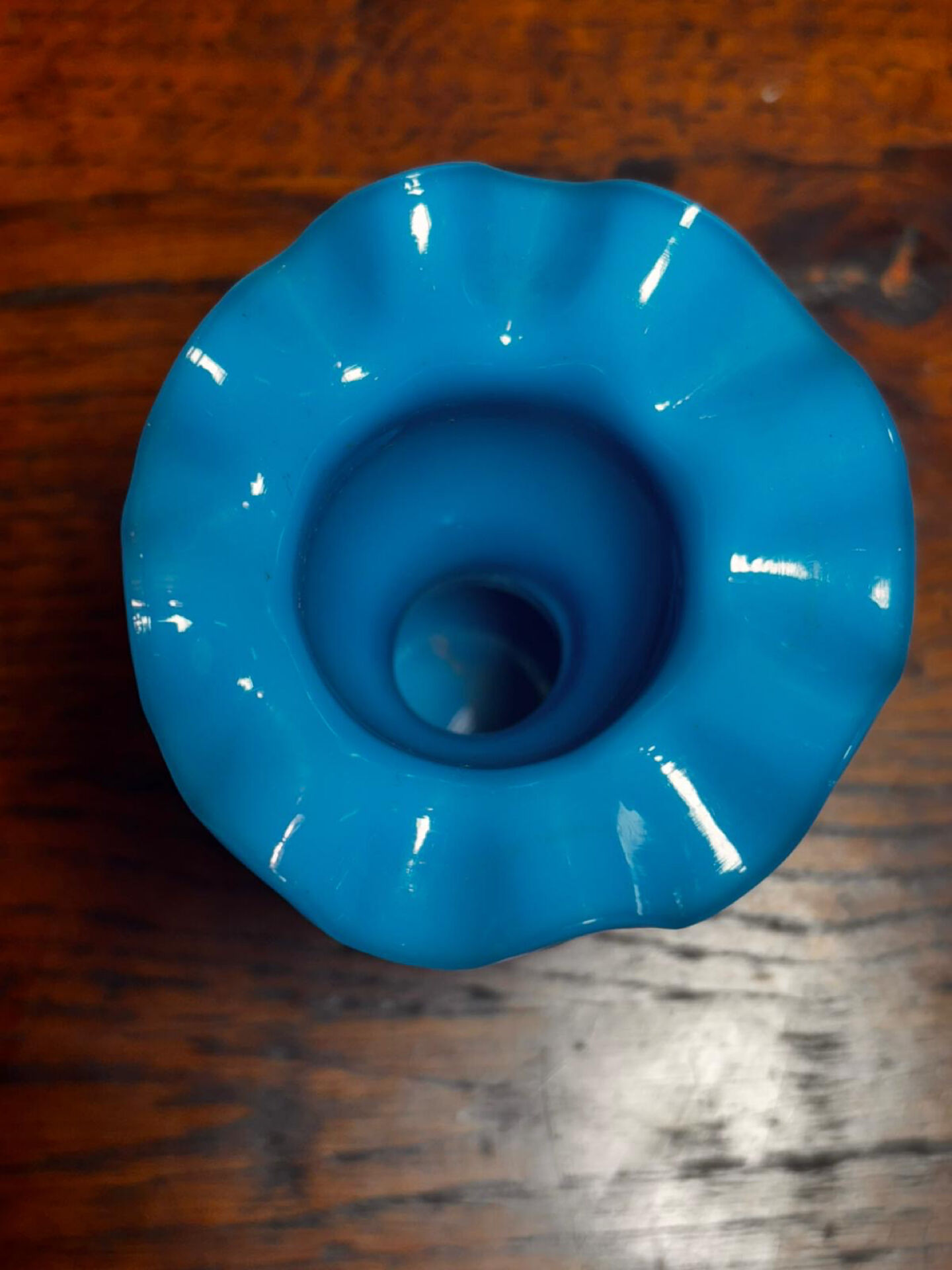 Blue opaline vase, opaque glass, wavy neck/rim, relief decoration of a bow.