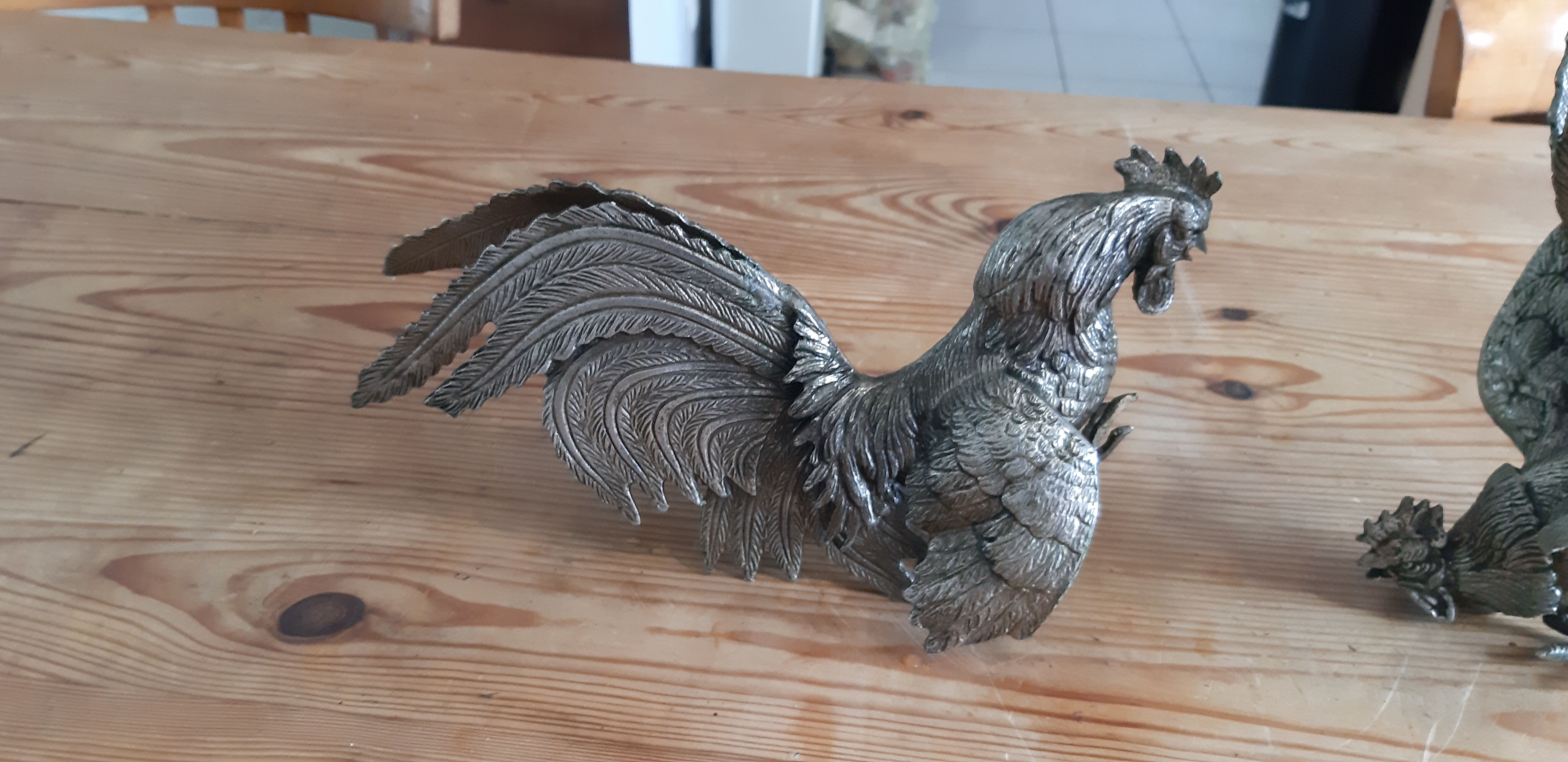 2 silver metal roosters