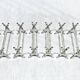 12 silver-plated metal knife handles, in a case.