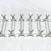 12 silver-plated metal knife handles, in a case.