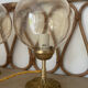 2 bedside lamps with round amber glass globes and gold metal.