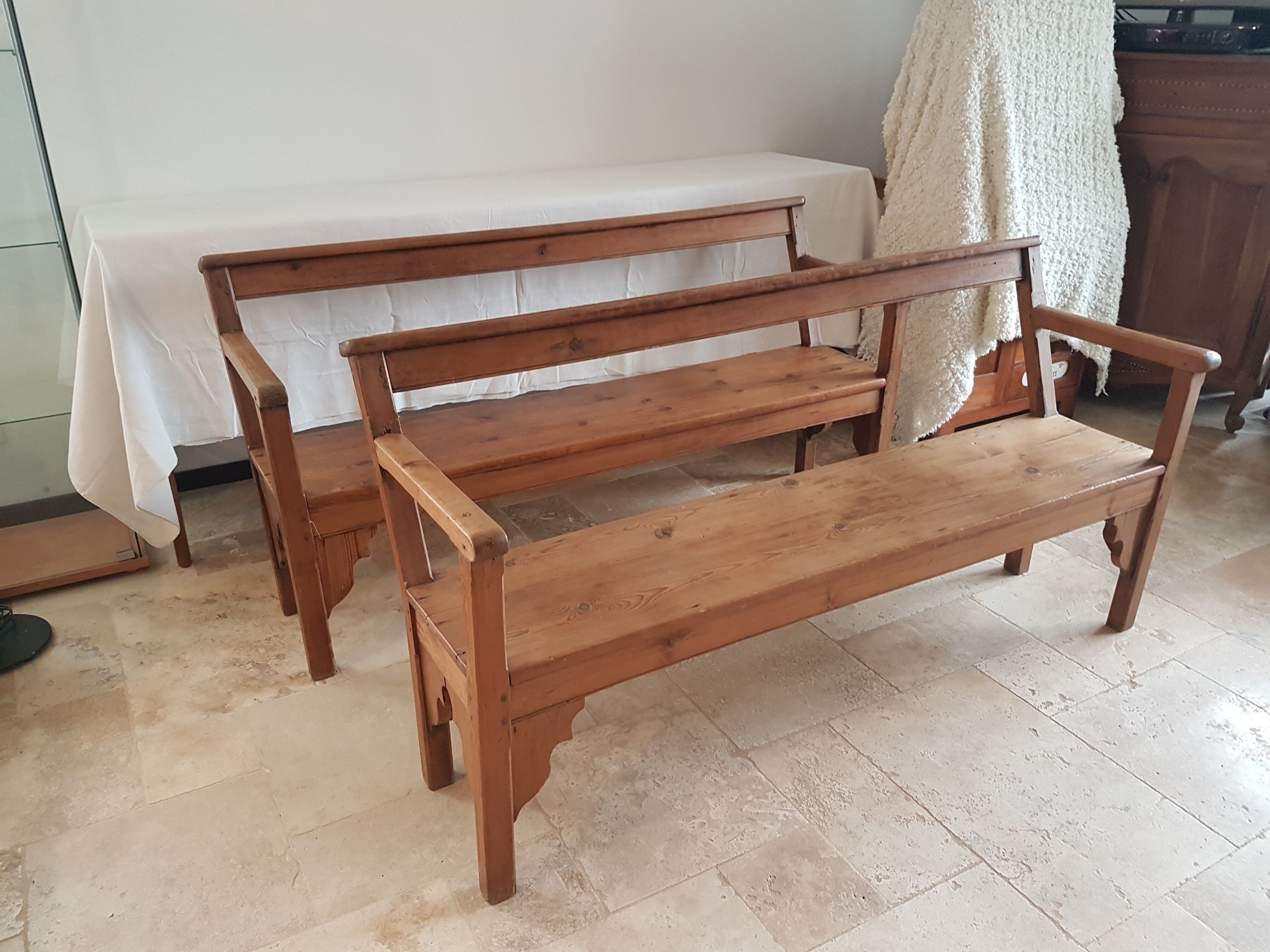Church bench in fir tree with armrests