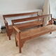 Church bench in fir tree with armrests